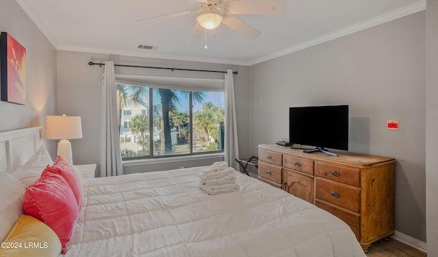 bedroom with ornamental molding and ceiling fan