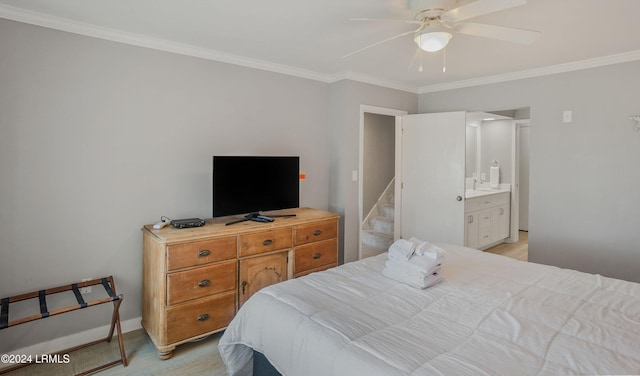 bedroom featuring ceiling fan, ensuite bath, ornamental molding, and sink