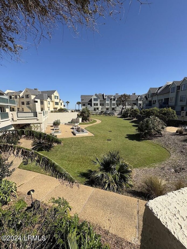 surrounding community with a patio area and a lawn