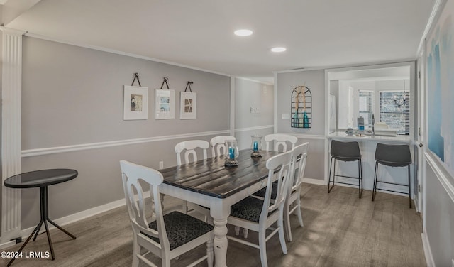 dining area featuring hardwood / wood-style floors and crown molding