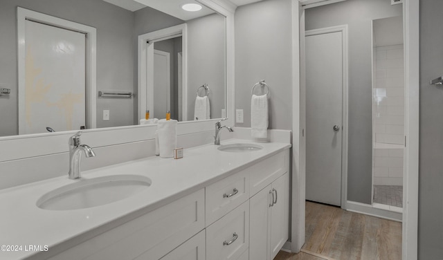 bathroom featuring vanity, a shower, and hardwood / wood-style floors