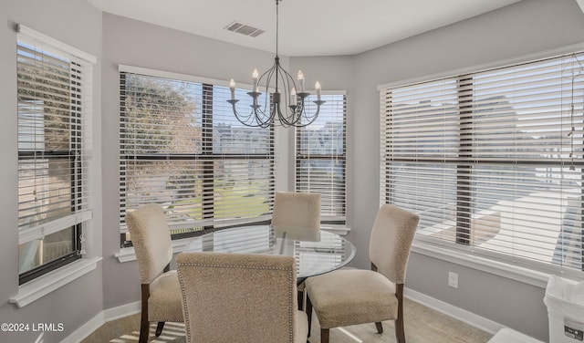 dining room with a notable chandelier and a healthy amount of sunlight