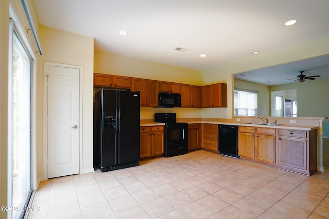 kitchen with sink, light tile patterned floors, ceiling fan, and black appliances