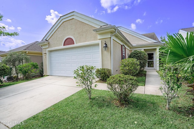 view of front of house with a garage and a front lawn