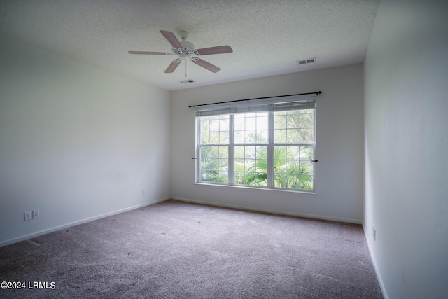 unfurnished room featuring ceiling fan, carpet flooring, and a textured ceiling