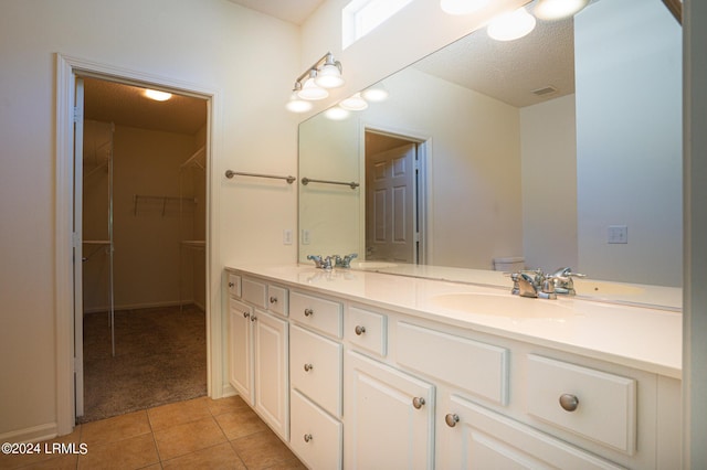 bathroom with vanity, tile patterned flooring, and a textured ceiling