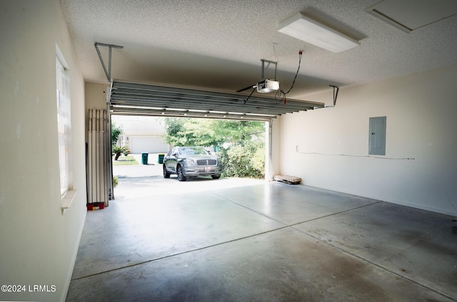 garage featuring a garage door opener and electric panel