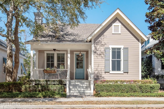 view of front of home featuring covered porch, a ceiling fan, and a shingled roof