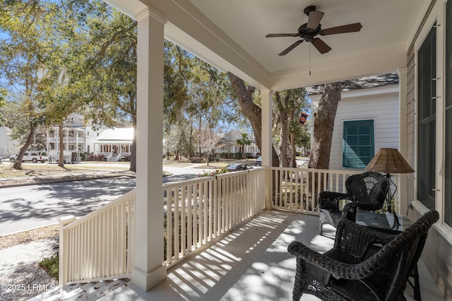 balcony featuring a residential view, a porch, and ceiling fan