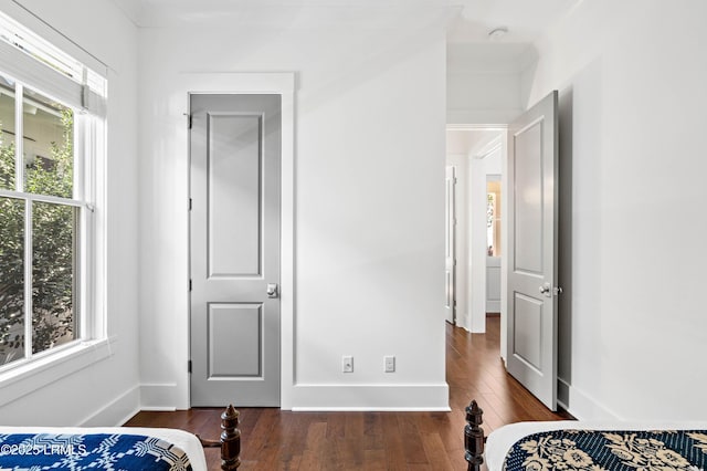 bedroom featuring baseboards and wood-type flooring