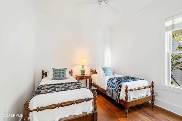 bedroom with ceiling fan, baseboards, and hardwood / wood-style floors