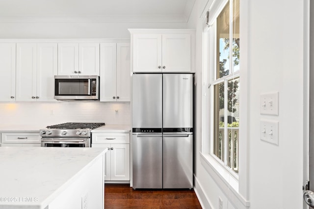 kitchen featuring plenty of natural light, white cabinets, appliances with stainless steel finishes, and dark wood-style flooring