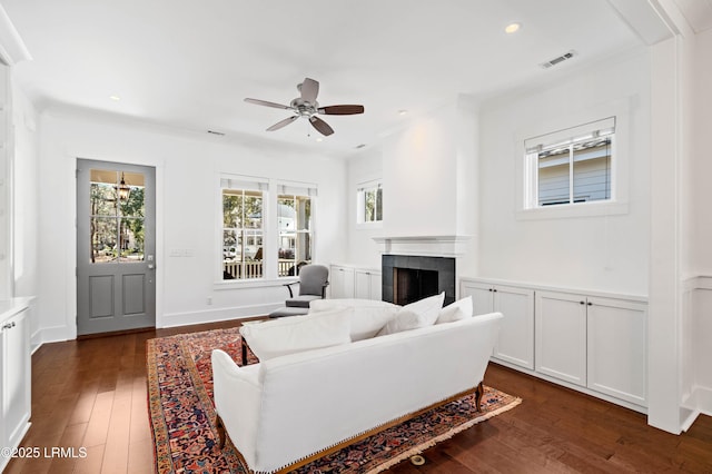 living area with visible vents, recessed lighting, dark wood-style flooring, ceiling fan, and a tile fireplace