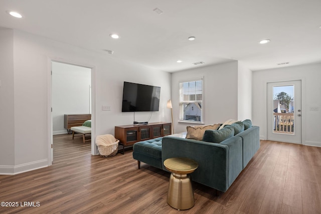 living room featuring plenty of natural light, recessed lighting, visible vents, and wood finished floors