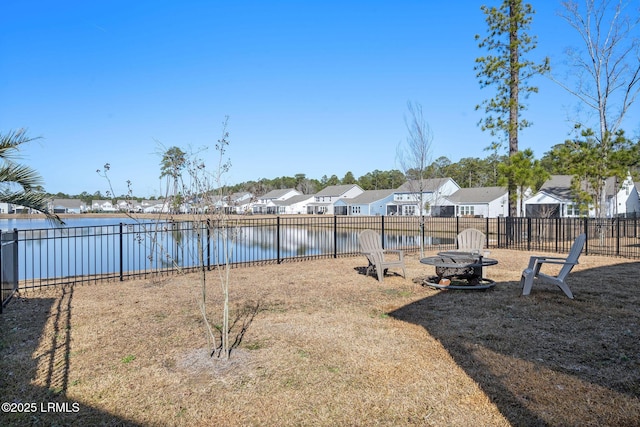 view of yard featuring a water view and an outdoor fire pit