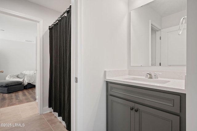 full bath featuring vanity, tile patterned floors, and ensuite bathroom