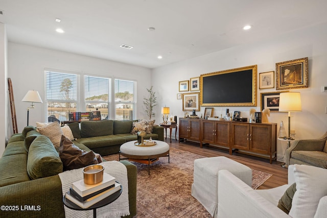 living area featuring visible vents, recessed lighting, and wood finished floors