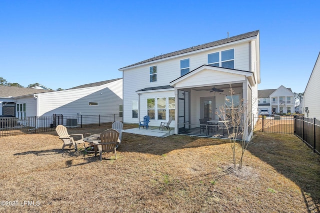 back of house featuring a fire pit, ceiling fan, a fenced backyard, a sunroom, and a patio