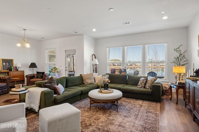 living room featuring an inviting chandelier and hardwood / wood-style flooring