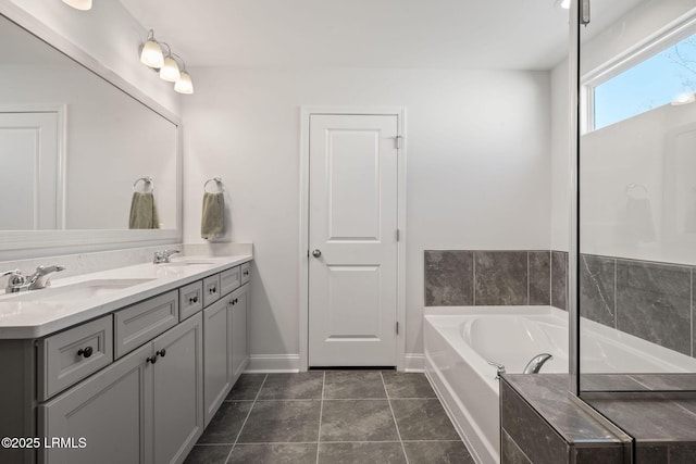 bathroom featuring tile patterned flooring, double vanity, a bath, and a sink