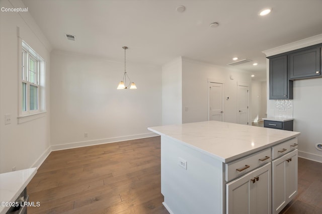 419 Parkside Commons, Bluffton, SC 29910 - kitchen with dark wood-style floors, recessed lighting, a center island, pendant lighting, and light stone countertops
