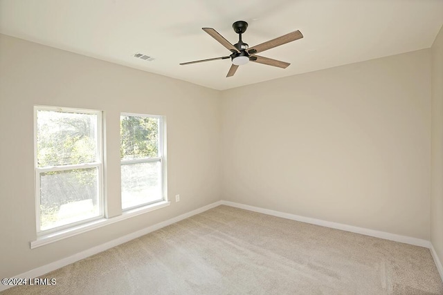 spare room featuring ceiling fan and light colored carpet