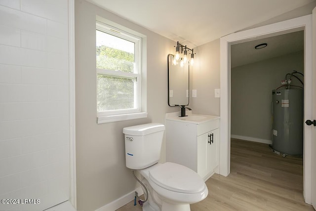 bathroom with toilet, vaulted ceiling, vanity, hardwood / wood-style floors, and water heater