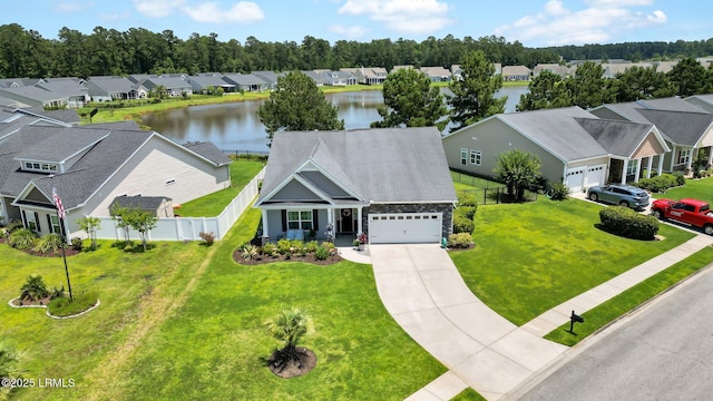 drone / aerial view featuring a residential view and a water view