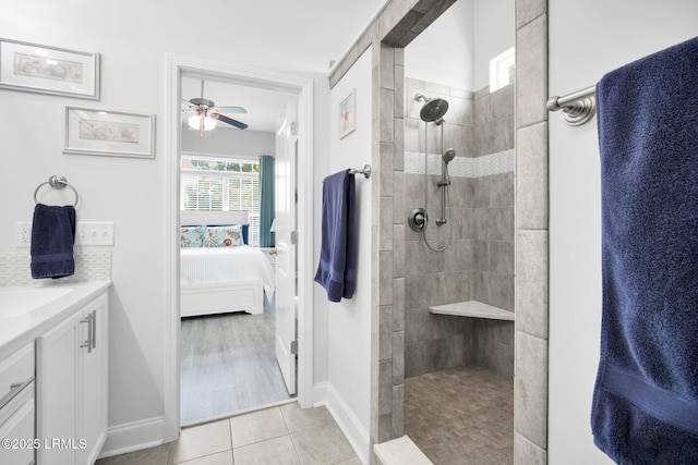 ensuite bathroom featuring tile patterned flooring, a walk in shower, vanity, and ensuite bathroom