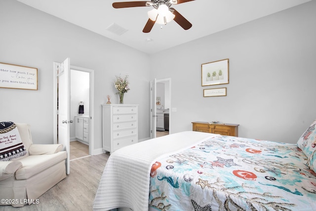 bedroom featuring visible vents, ensuite bath, ceiling fan, a sink, and light wood-style floors