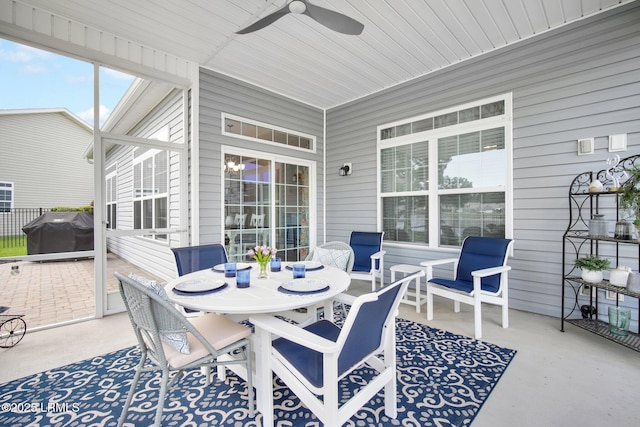 view of patio featuring grilling area, outdoor dining area, and a ceiling fan