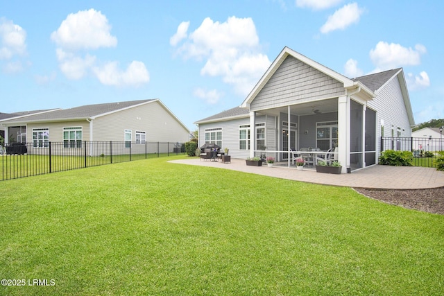 rear view of property with a ceiling fan, a fenced backyard, a yard, a sunroom, and a patio area