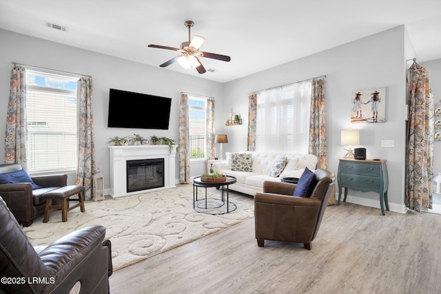 living room featuring hardwood / wood-style flooring and ceiling fan