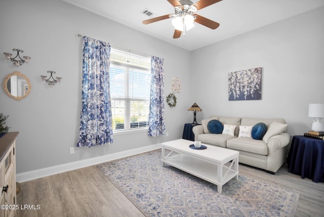 living room featuring hardwood / wood-style flooring and ceiling fan