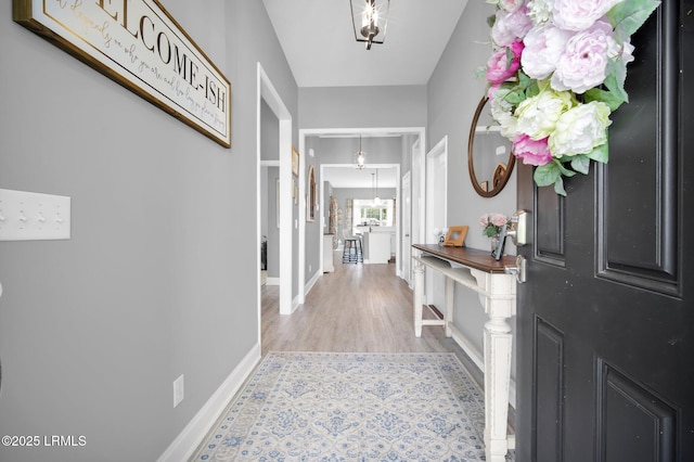 interior space featuring baseboards and wood finished floors