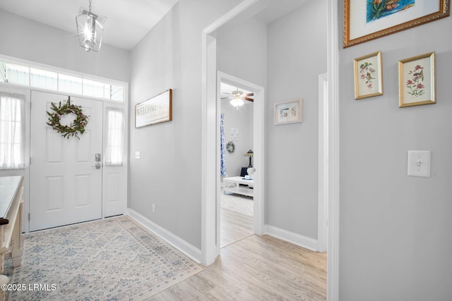 foyer featuring light wood-style flooring and baseboards