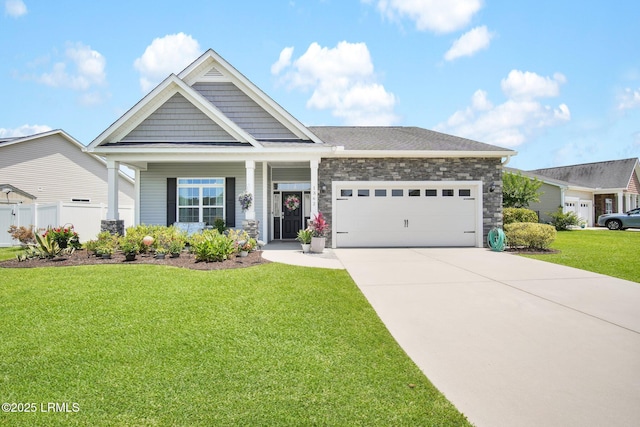 view of front facade featuring a front lawn, an attached garage, stone siding, and concrete driveway