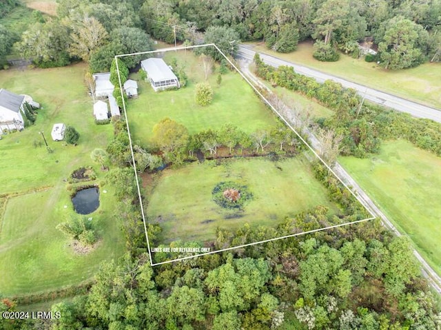 birds eye view of property with a rural view