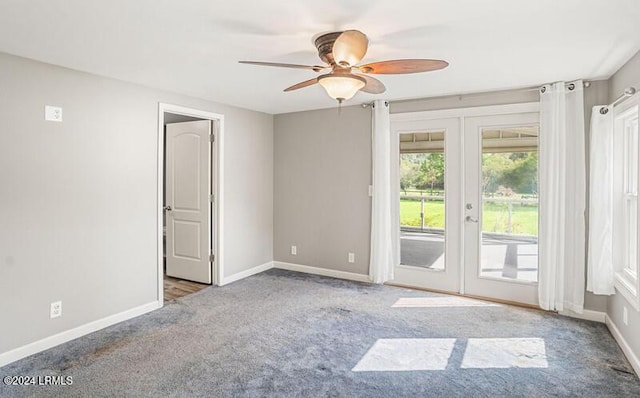 carpeted empty room with french doors and ceiling fan