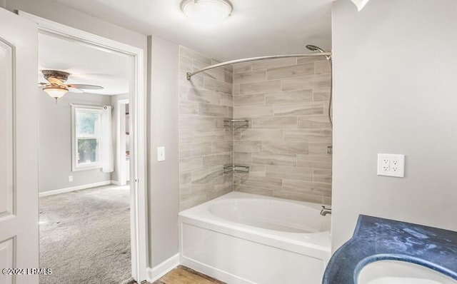 bathroom with tiled shower / bath combo, sink, and ceiling fan