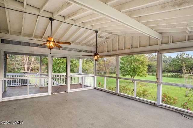 unfurnished sunroom with ceiling fan and vaulted ceiling