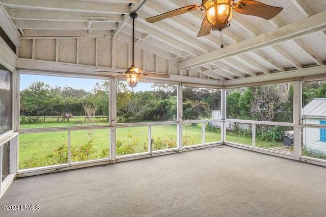 unfurnished sunroom with vaulted ceiling and ceiling fan