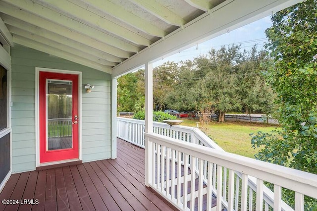 wooden deck featuring a yard