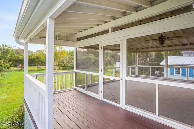 unfurnished sunroom with lofted ceiling and ceiling fan