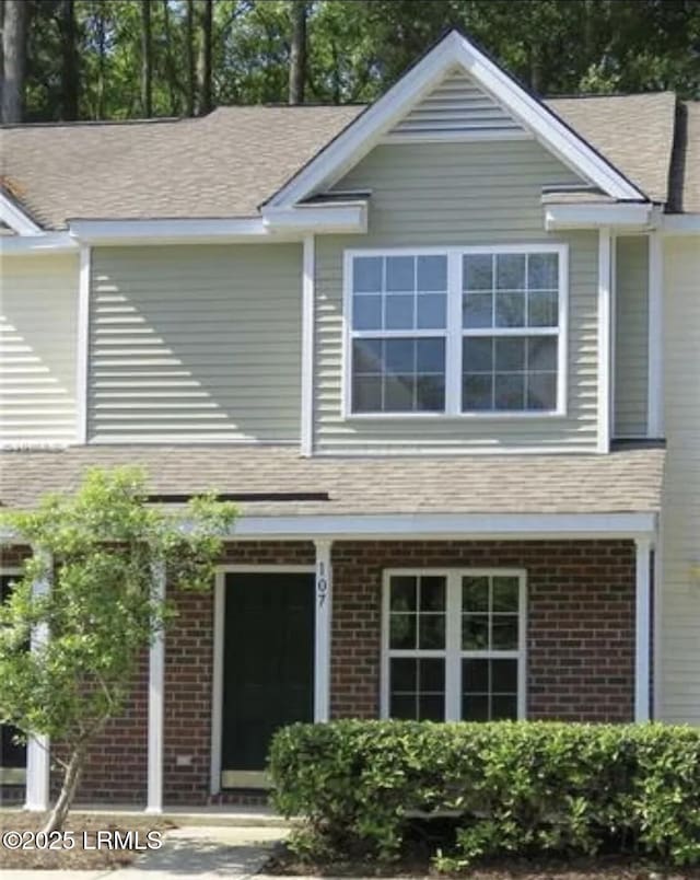 107 S St, Bluffton, SC 29910 - view of front of house with brick siding and a shingled roof