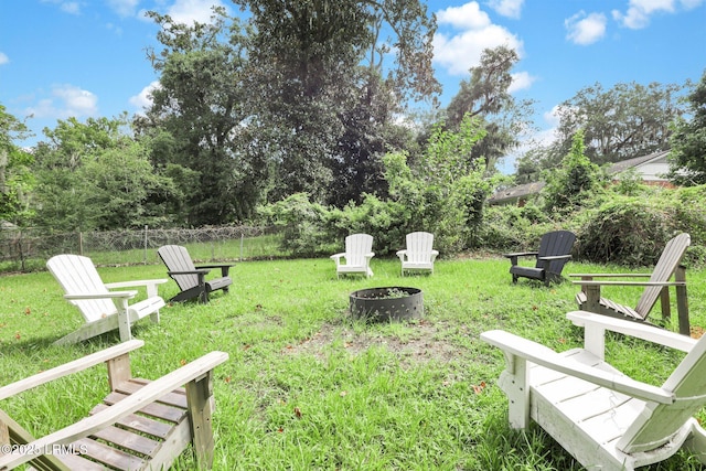 view of yard featuring a fire pit and fence