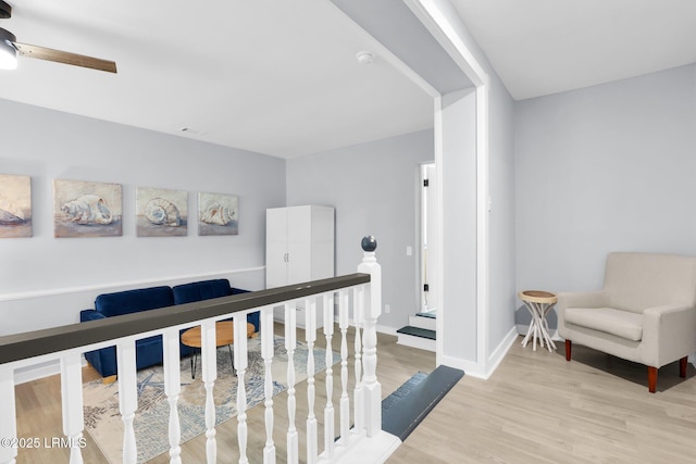 hall featuring wood finished floors and baseboards