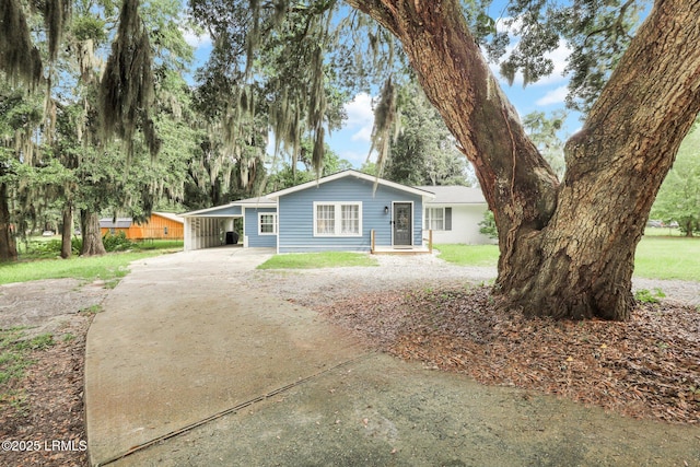 single story home with driveway and an attached carport