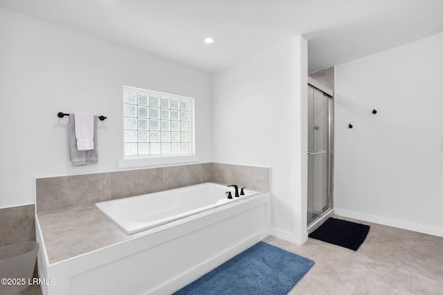 bathroom featuring a bath and a stall shower