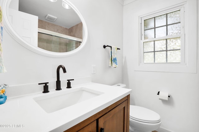 bathroom with visible vents, a stall shower, toilet, and vanity